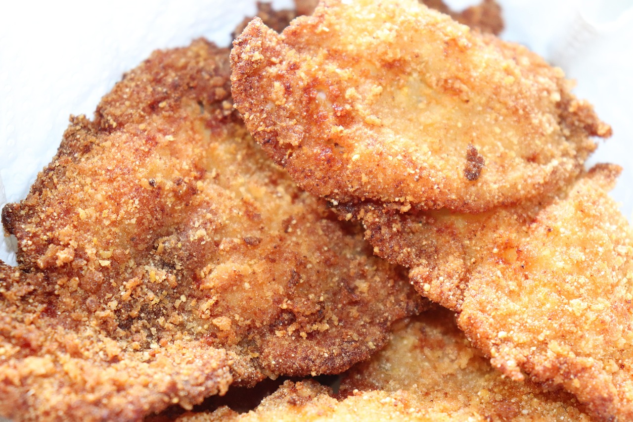 chicken breast on the stove &mdash; golden pan-fried breast searing in a hot skillet