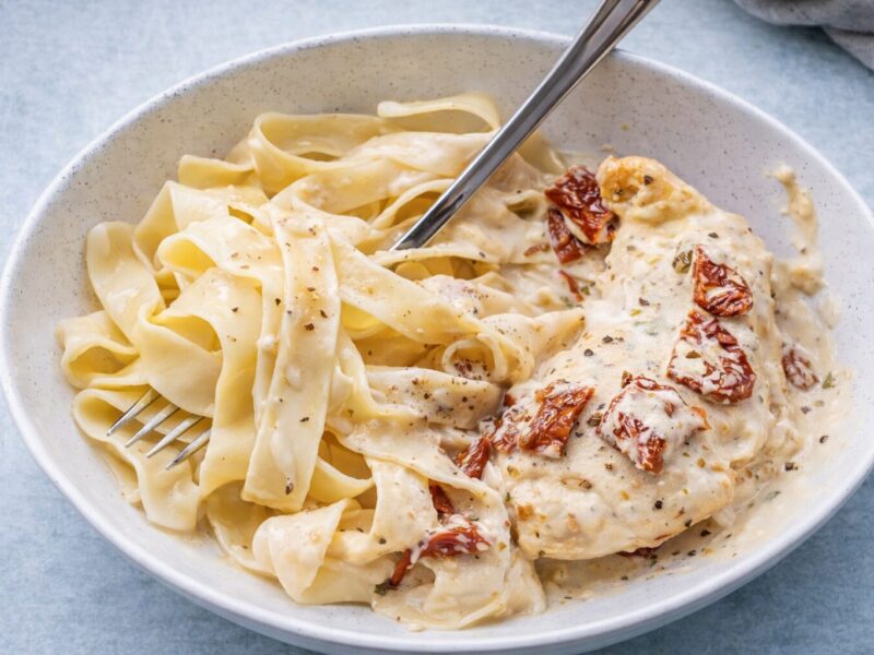 Creamy chicken pasta with sun-dried tomato in a bowl