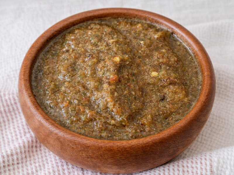 Authentic Jamaican jerk chicken seasoning wet marinade paste with allspice, thyme and scotch bonnet in a wooden bowl