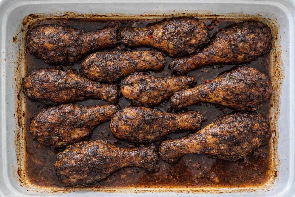 Oven baked jerk chicken thighs with crispy caramelized skin fresh from the oven