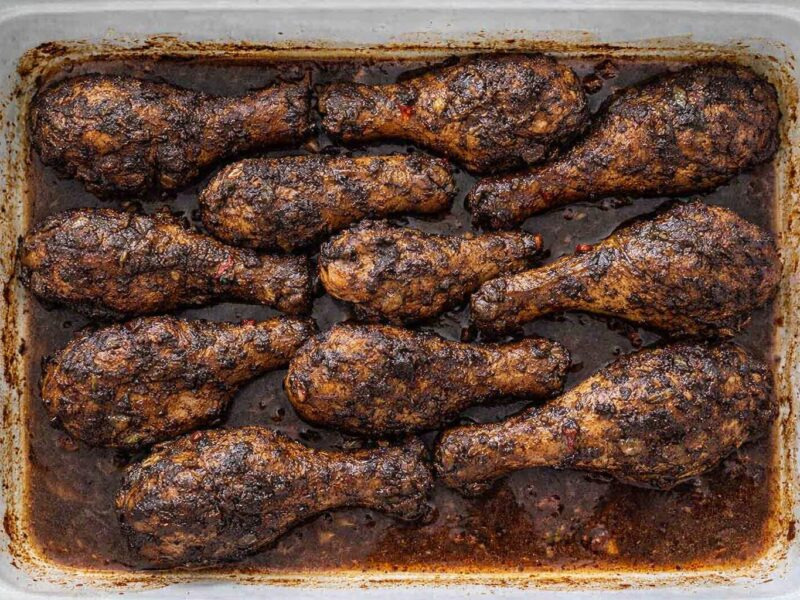 Oven baked jerk chicken thighs with crispy caramelized skin fresh from the oven