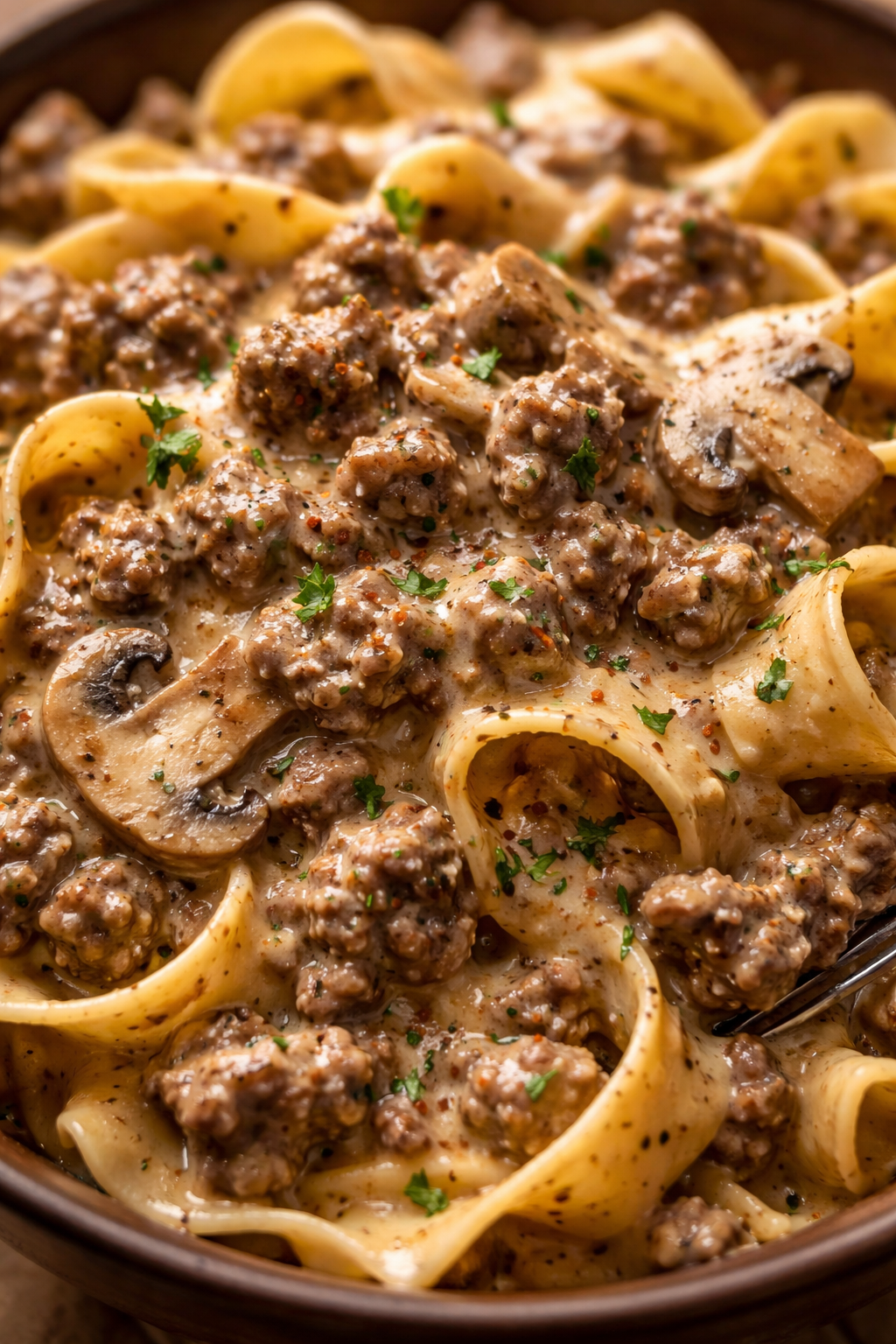 Bowl of ground beef stroganoff with cream of mushroom soup over egg noodles