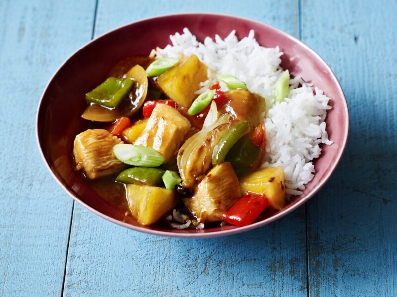 Sweet and sour chicken with pineapple and bell peppers in a glossy sauce