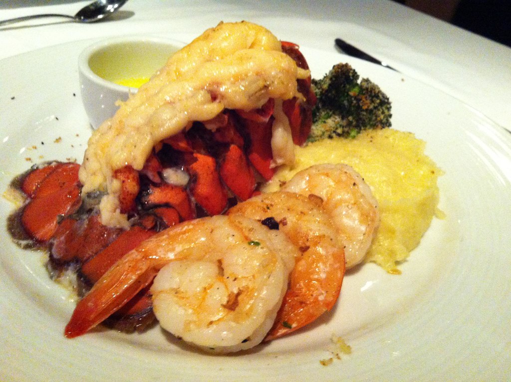 Broiled Maine lobster tail with the meat piggybacked on the shell, served with jumbo shrimp and a cup of drawn butter